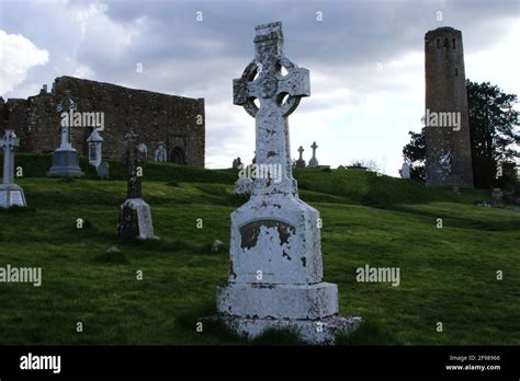 Clonmacnoise Cathedral with the typical crosses and graves. The ...