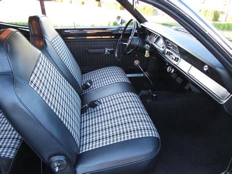 the interior of a car with black and white checkered cloth on it's seat covers