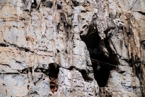 Bat Cave Entrance on Cliff of Rock Mountain Stock Image - Image of ...