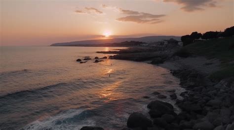 Premium AI Image | Aerial shot of a beach with a sunset in the background.