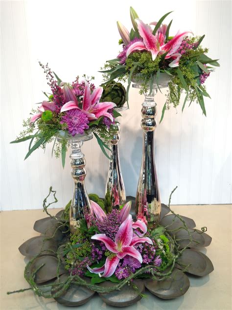 A magnificent three tier arrangement with star gazer lilies, as the ...