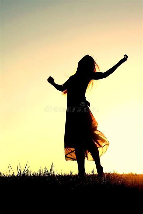 Silhouette Of Woman Dancing And Praising God At Sunset Stock Photo ...