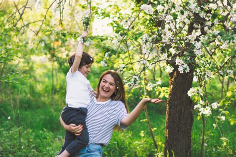 Happy mother's day. Mother with little baby son in spring garden during ...