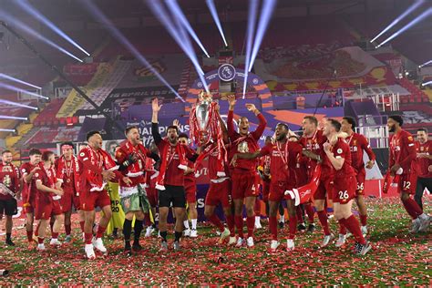 Liverpool players receive Premier League trophy on Kop