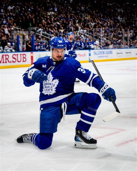 an ice hockey player in blue uniform on the ice