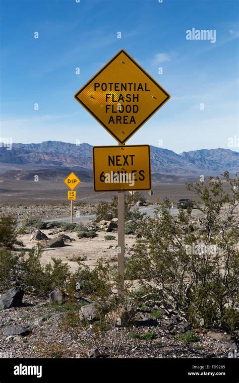 Flash flood warning signs aon the roadside in Death Valley California ...