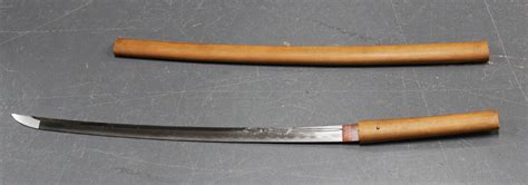 A Japanese slightly curved single edged katana blade with wavy yakiba, length approx 70.5cm, one sid