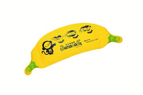 Pillow in yellow in the shape of a banana, with both ends compressed to ...