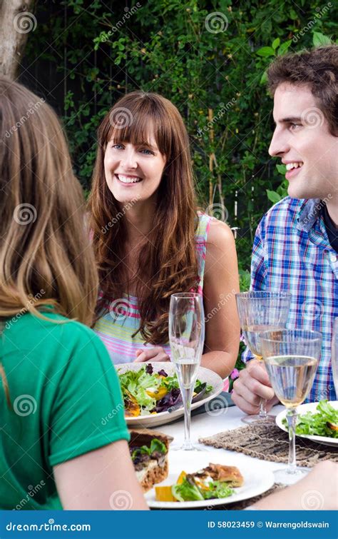 Friends Enjoying Food and Drinks at a Gathering Stock Image - Image of ...