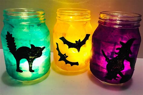 three mason jars with halloween decorations painted on them, one has bats and the other has bat's