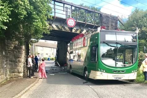 Fauldhouse crash: Bus roof ripped off after smashing into railway ...