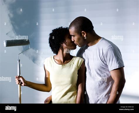 couple painting a room Stock Photo - Alamy