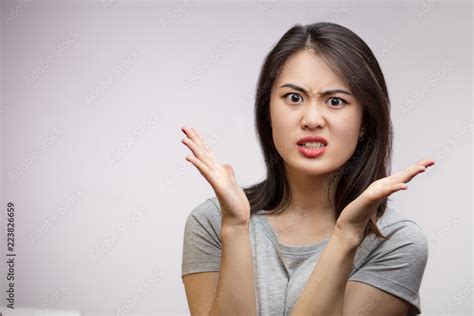 Portrait young angry Asian female unhappy, annoyed by something, isolated over white background ...