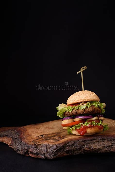 Delicious Homemade Burger on Rustic Wooden Board, Dark Background. Copy ...