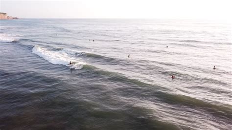 Premium stock video - Surfing at olon beach, ecuador - tourists having fun on riding ocean waves