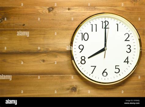 wall clock on the wooden wall at time 8am or 8pm Stock Photo: 120005778 - Alamy