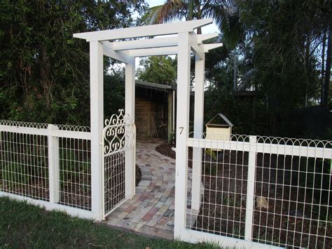 a white gated entrance to a home