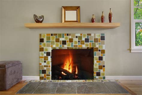 Recycled glass fireplace with cantilevered wood slab mantle. | Glass tile fireplace, Fireplace ...