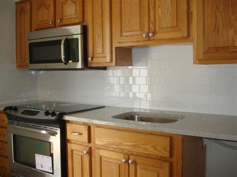 Clean and simple kitchen backsplash: white 3x6 subway tile and bri… | White tile kitchen ...