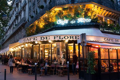 the outside of a restaurant with people sitting at tables in front of ...