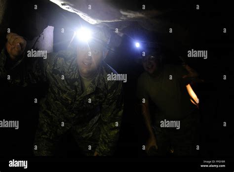 Master Sgt. Rusty Chase climbs through a cave during a tour of Iwo To ...