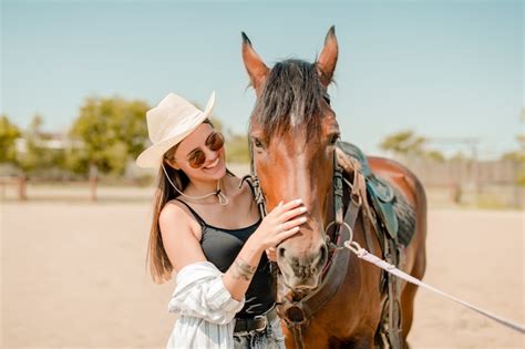 Premium Photo | Country girl on a ranch with a brown horse