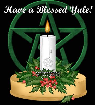 a lit candle with holly leaves on it and the words have a blessed yule