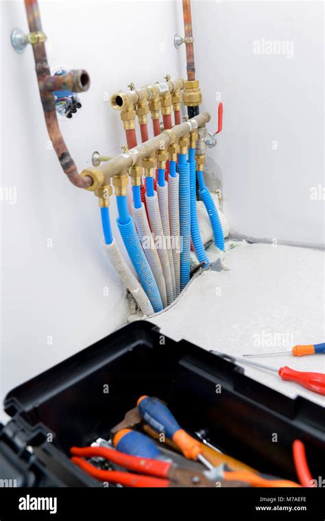 Plumber installing a system of piping Stock Photo - Alamy