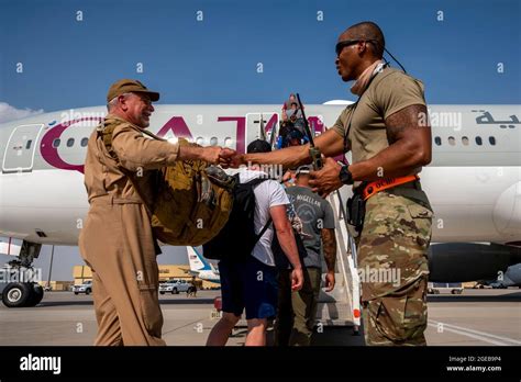 Al Udeied Air Base, Qatar. 17th Aug, 2021. U.S. Embassy personnel ...