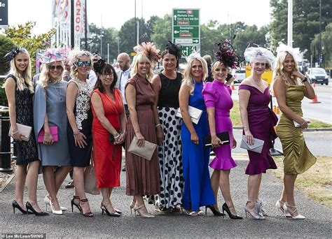 Ladies Day revellers at Doncaster Races brave showery conditions in colourful thigh-skimming ...