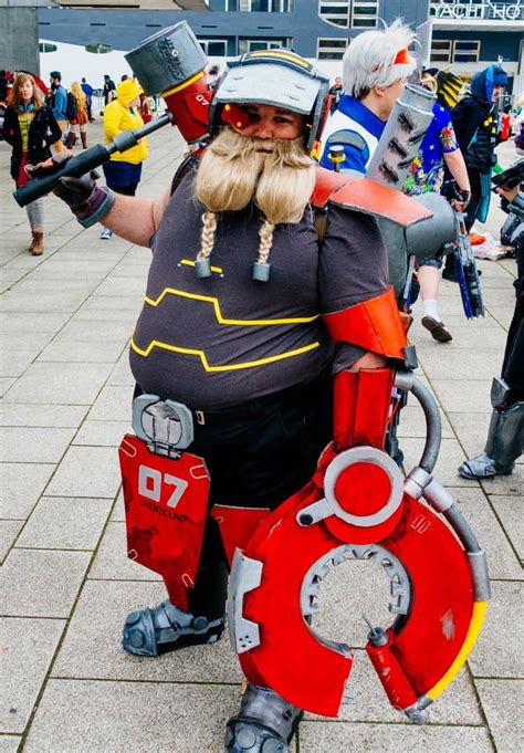 a man dressed in costume is standing on the sidewalk