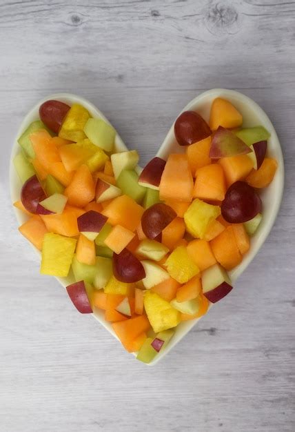 Premium Photo | Heart Healthy Fruit Salad Concept on Wood Background