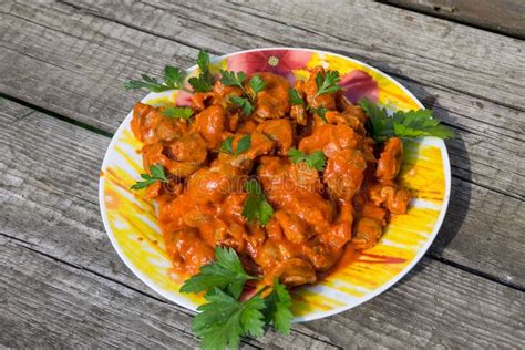 Chicken Gizzard Stew in Plate on Rustic Wooden Table Stock Photo ...