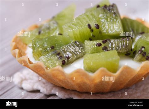 tart with kiwi fruit and cream close up on the table. horizontal. macro ...