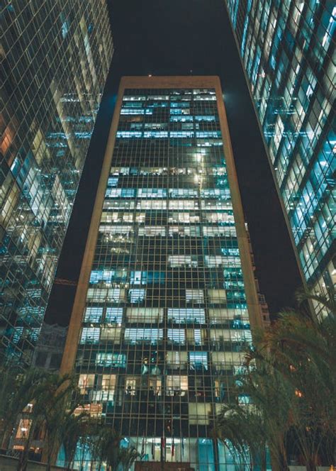 3 Tall Buildings At Night Time · Free Stock Photo