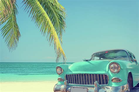 Classic Car On A Tropical Beach With by Delpixart