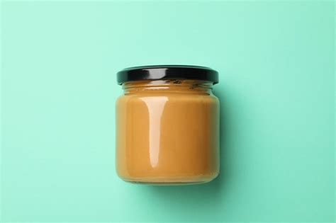 Premium Photo | Blank jar with peanut butter on mint background