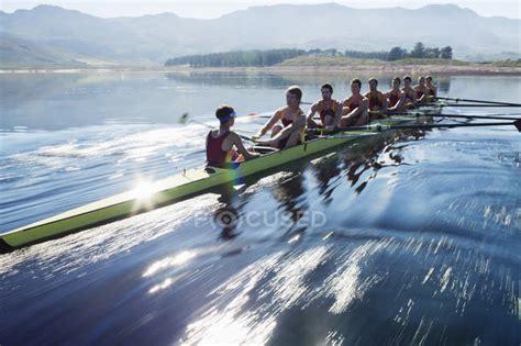 Rowing team rowing scull on lake — sunny, world sports event - Stock Photo | #199751666