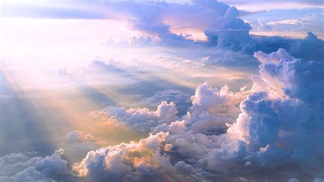 the sky is filled with lots of clouds and sun beams shining down on top of them
