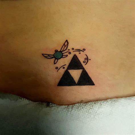 a woman's chest with a tattoo on it that has an image of the legend of zelda