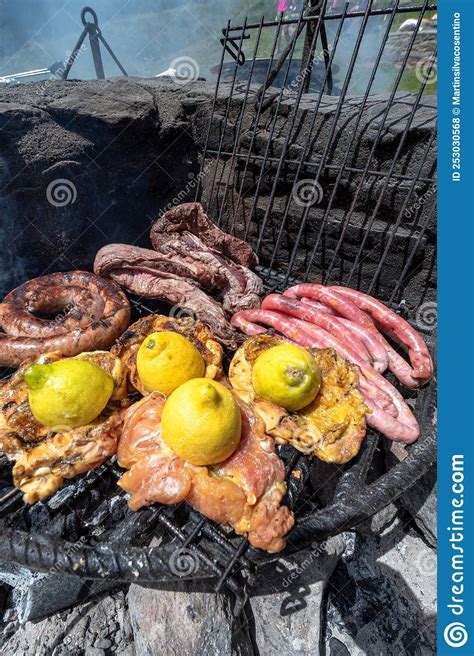 Typical Uruguayan and Argentine Asado Cooked on Fire. Entrana and Vacio Meat Cuts Stock Photo ...