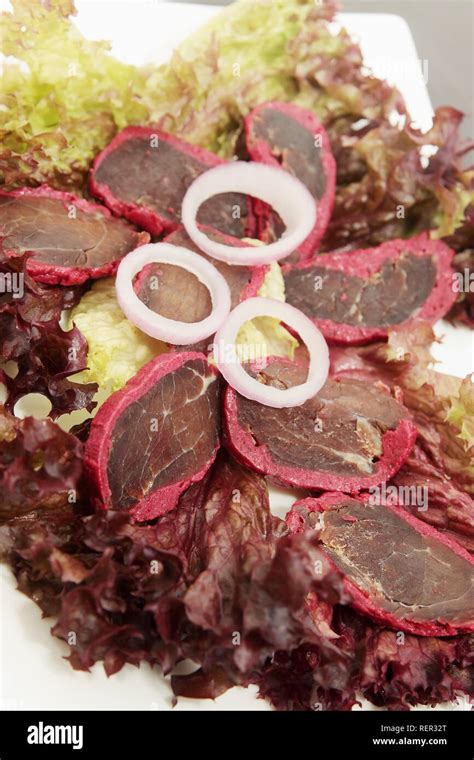 basturma with spices and onions on salad leaves Stock Photo - Alamy