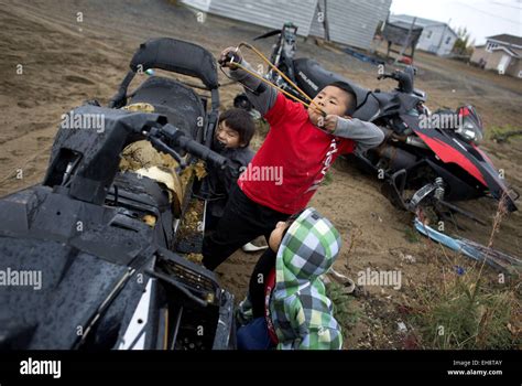 Natuashish, Newfoundland and Labrador, Canada. 28th Sep, 2014. Children fire stones with a sling ...