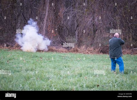 Man shooting off 303 british rifle at target of tannerite setting off an explosion, Fallston ...