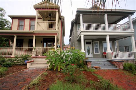 two large houses with porches and balconies on the second floor are shown