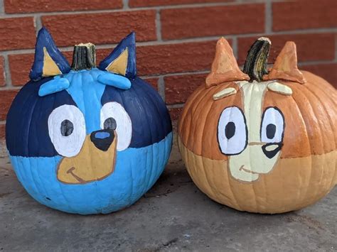 two pumpkins painted to look like cartoon characters