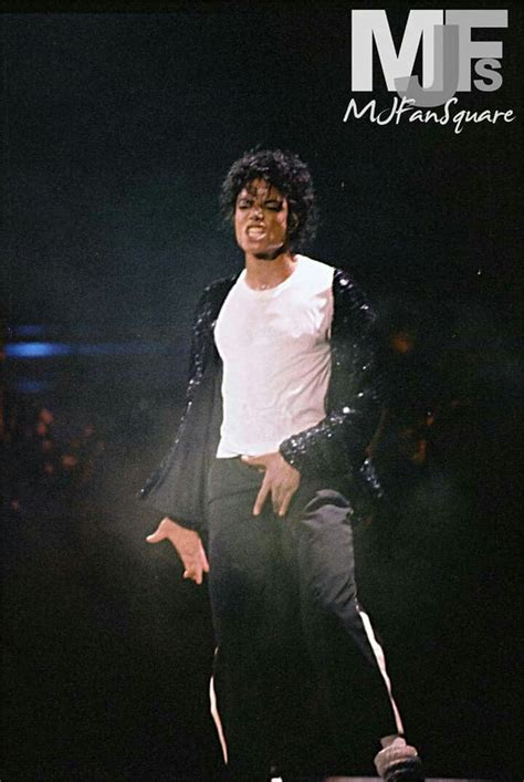 michael jackson performing on stage during a concert with his hands in ...