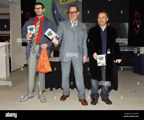 (l-r) Angelos Epithemiou, Vic Reeves and Bob Mortimer pose for photographs before signing copies ...