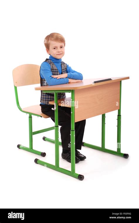 Boy sitting at a school desk isolated on white Stock Photo - Alamy