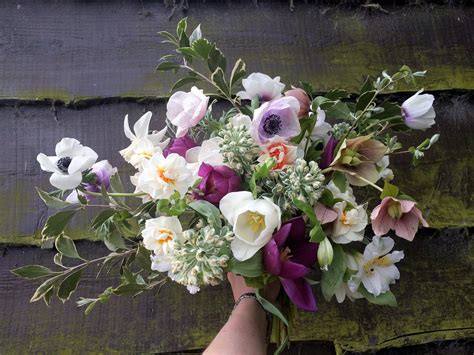 Beautiful British wedding bouquet of spring flowers. Featuring Hellebores, anemones and ...